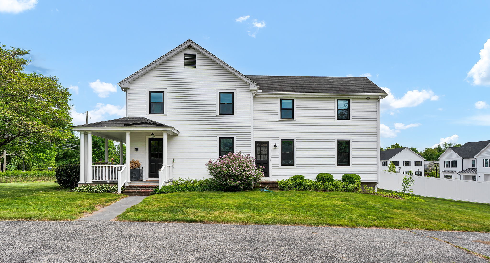 235 Addison Road Glastonbury, CT 06033 - Photo 1 of 1 a view of a white house with a big yard plants and large trees