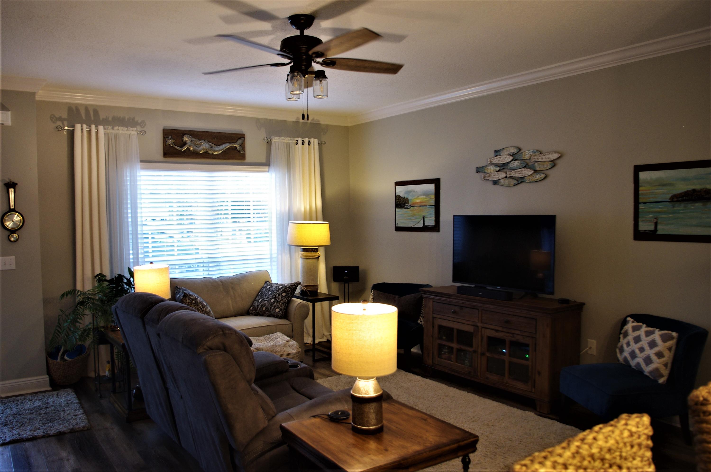 70 Beacon Point Drive Santa Rosa Beach, FL 32459 - Photo 3 of 19 a living room with furniture and a flat screen tv