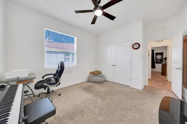 a view of a workspace with furniture and a window