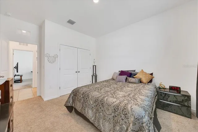 a bedroom with a bed and a couch