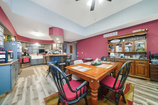 a bathroom with a sink a toilet a mirror and shower curtain