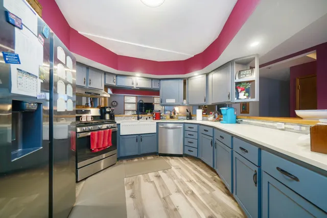 a bathroom with a sink a toilet a mirror and shower curtain