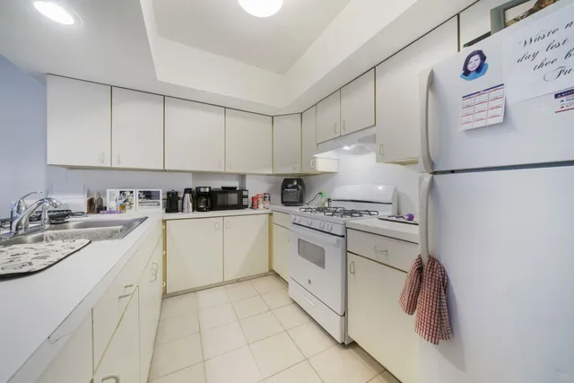 a bathroom with a granite countertop sink a toilet and shower