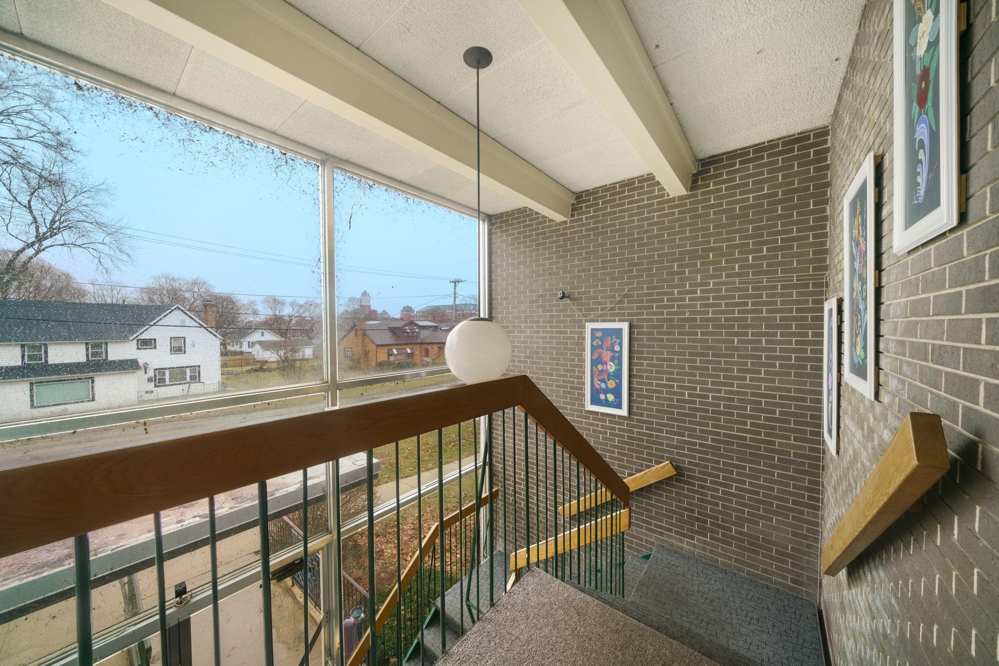 709 Franklin Street Oregon, IL 61061 - Photo 57 of 87 a view of a balcony with furniture and wooden floor