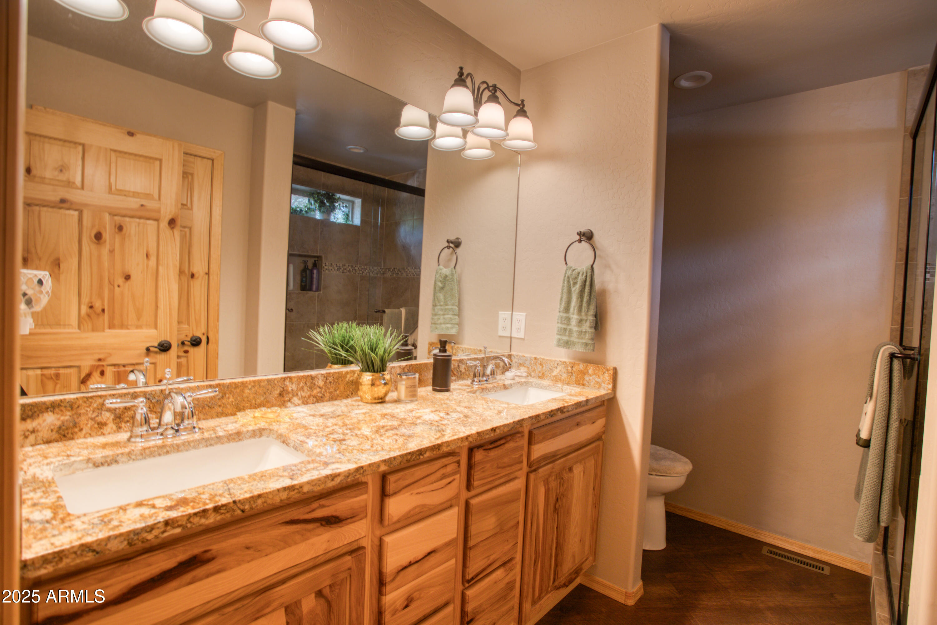 2050 Christmas Pine Road Overgaard, AZ 85933 - Photo 16 of 31 a bathroom with a double vanity sink and a mirror