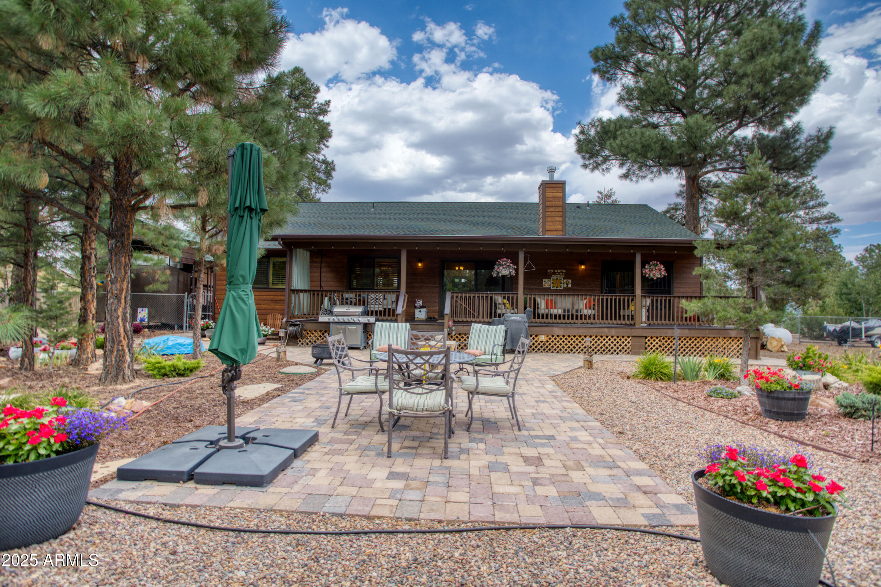 2050 Christmas Pine Road Overgaard, AZ 85933 - Photo 5 of 31 a view of a house with backyard sitting area and garden