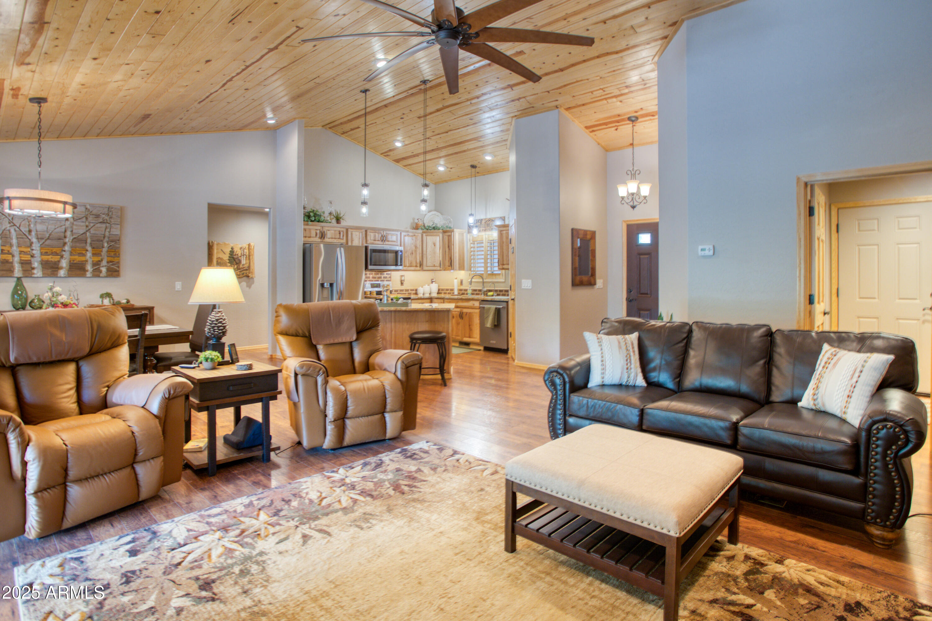 2050 Christmas Pine Road Overgaard, AZ 85933 - Photo 6 of 31 a living room with furniture and a chandelier
