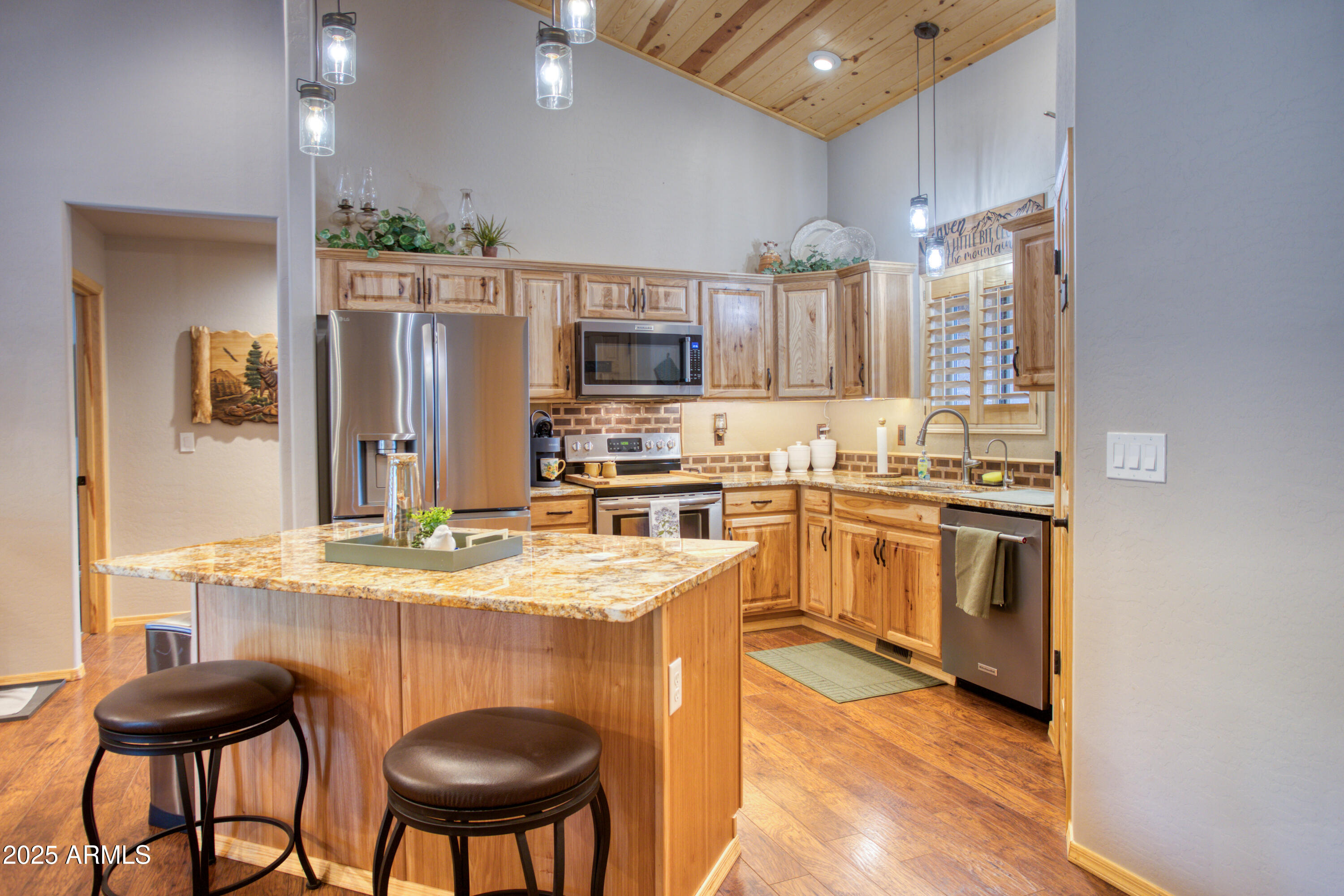 2050 Christmas Pine Road Overgaard, AZ 85933 - Photo 8 of 31 a kitchen with stainless steel appliances granite countertop a stove a sink a microwave a refrigerator and chairs