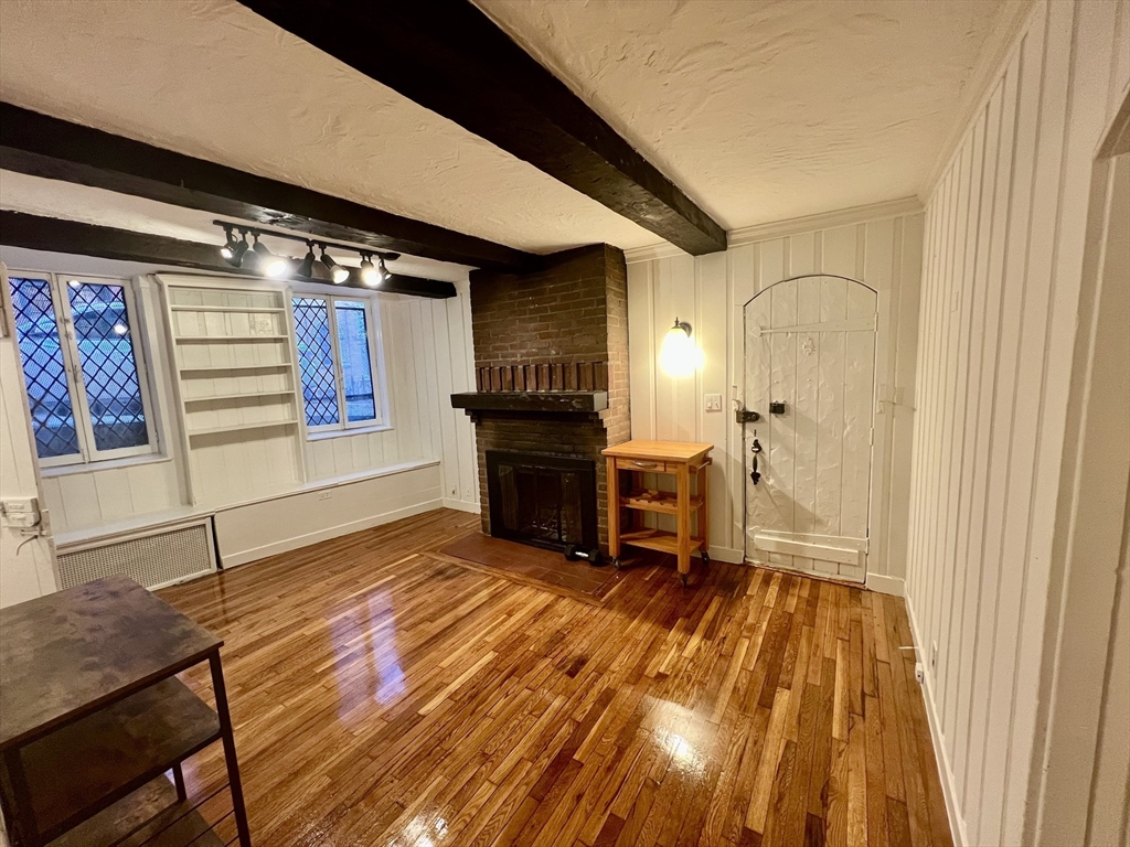 101 Myrtle Street, Unit A Boston, MA 02114 - Photo 4 of 15 a view of a livingroom with furniture and a fireplace