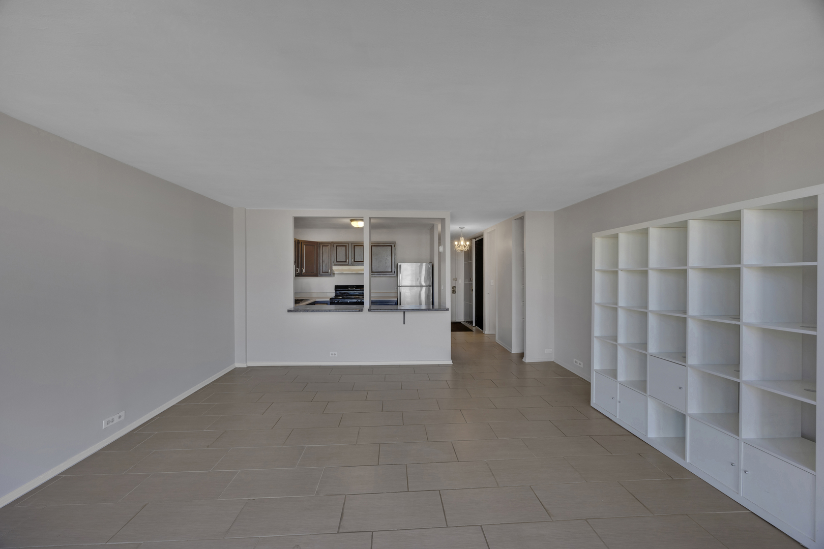 2901 South Michigan Avenue, Unit 908 Chicago, IL 60616 - Photo 22 of 22 a view of a livingroom with wooden floor and a cabinet