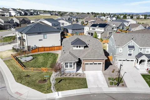 an aerial view of residential houses with outdoor space and parking