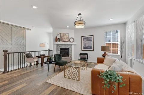 a living room with furniture kitchen view and a fireplace