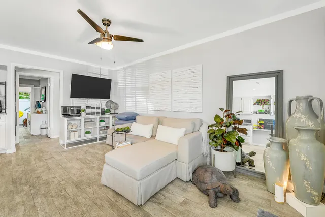 a living room with furniture a flat screen tv and a large window