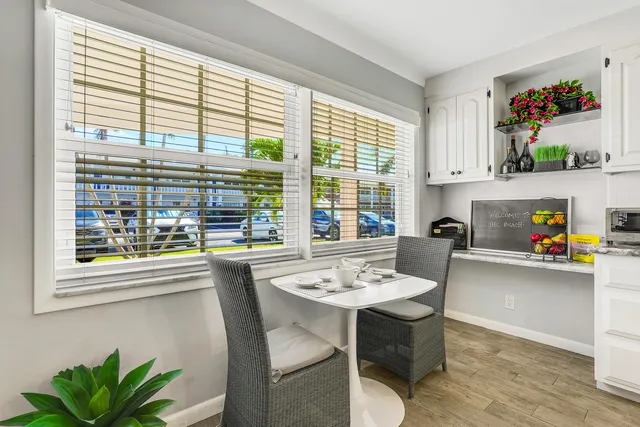 a dining room with furniture and a window