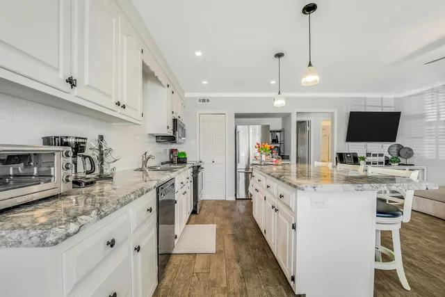 a large kitchen with kitchen island granite countertop lots of counter top space