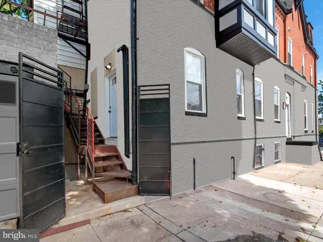 a kitchen with a dining table chairs and refrigerator