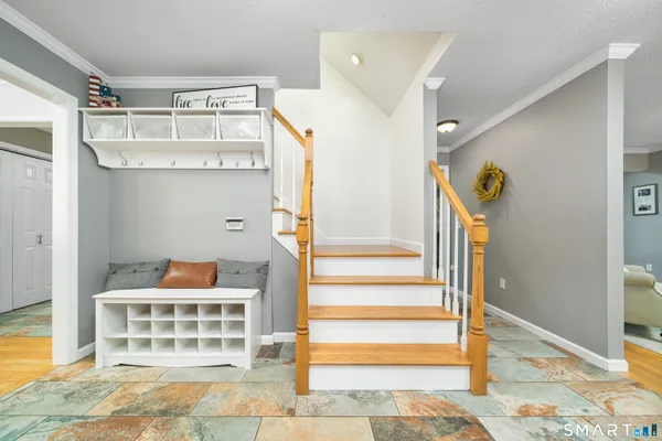 a view of entryway and hall with wooden floor