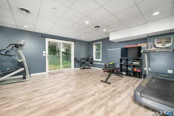 a view of a room with gym equipment and a large window