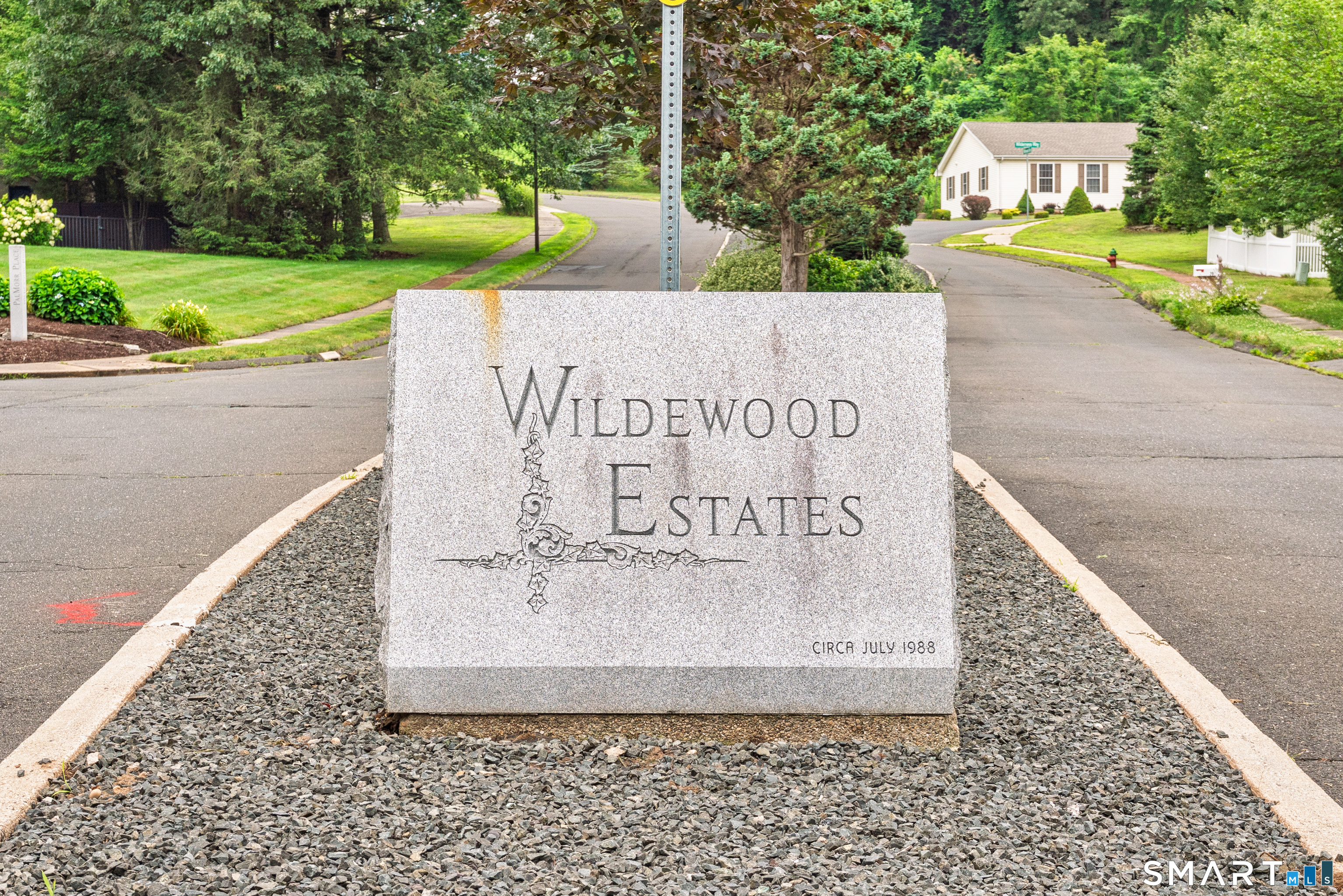 85 Wildewood Run Bristol, CT 06010 - Photo 29 of 29 a sign on the side of a building