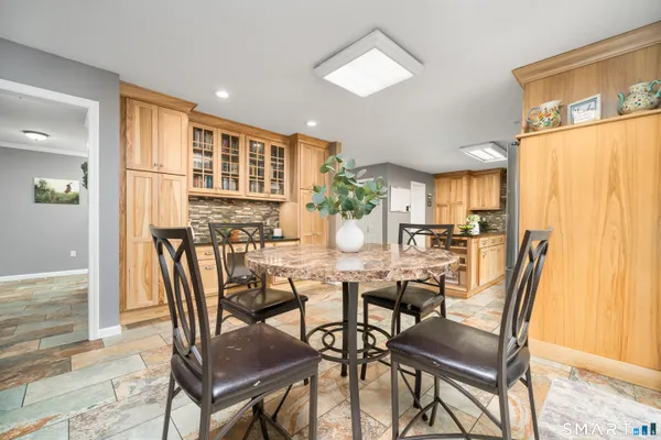 a view of a dining room with furniture and a window