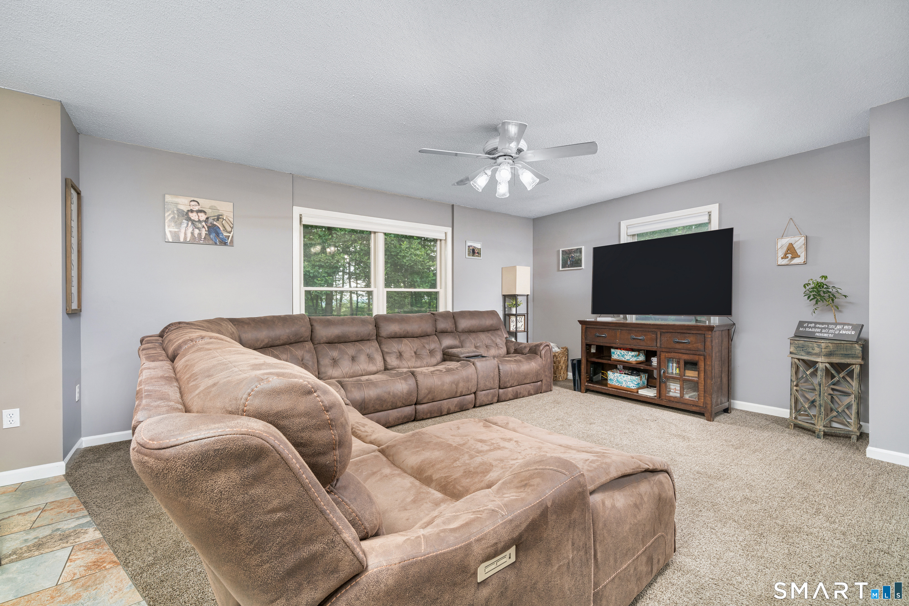 85 Wildewood Run Bristol, CT 06010 - Photo 8 of 29 a living room with furniture and a flat screen tv