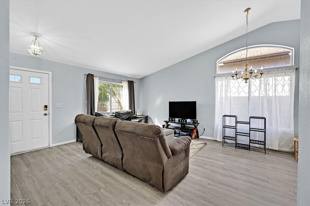 8830 Haviland Road Las Vegas, NV 89123 - Photo 3 of 43 Vaulted ceilings and wide-plank flooring define this inviting living area.