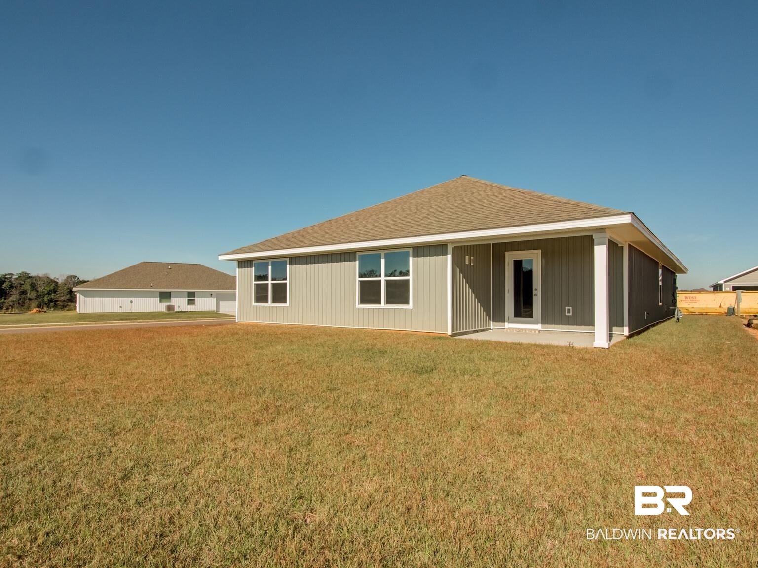 23953 Citation Loop Daphne, AL 36526 - Photo 31 of 49 Rear view of house with a shingled roof, a lawn, and a patio area