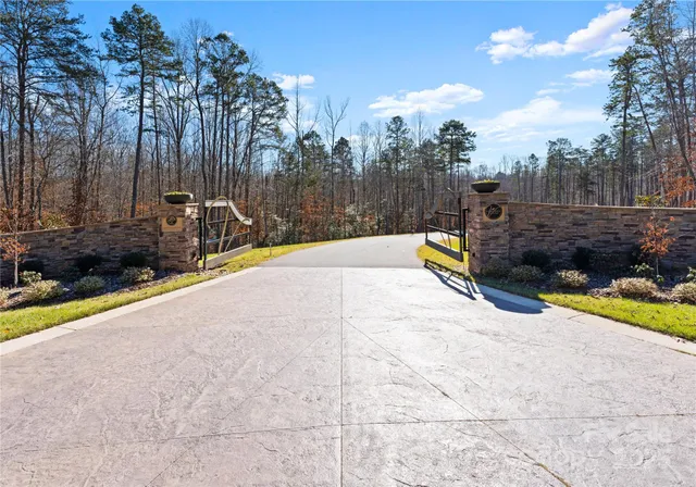a view of a swimming pool with a patio and a yard