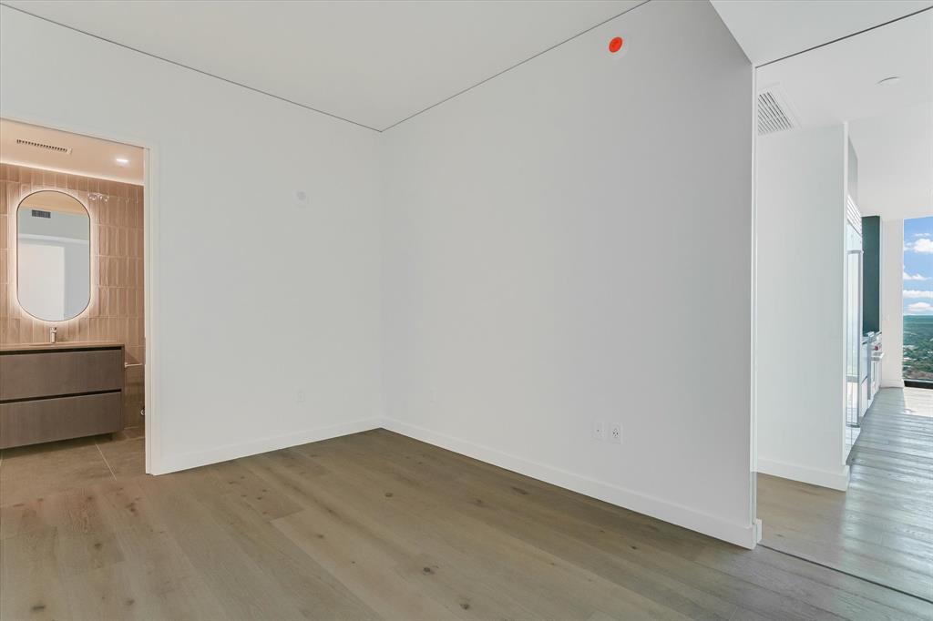 610 Davis Street, Unit 4201 Austin, TX 78701 - Photo 14 of 40 Empty room with light wood-style flooring and baseboards