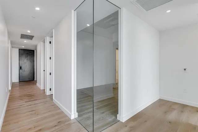 a view of empty room with wooden floor
