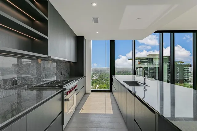 a view of a kitchen with a large window