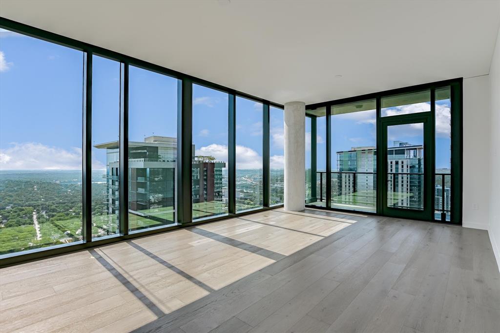 610 Davis Street, Unit 4201 Austin, TX 78701 - Photo 7 of 40 Unfurnished room with a wall of windows and wood finished floors
