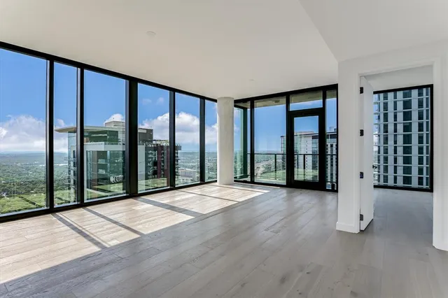 a view of a room with wooden floor and city view
