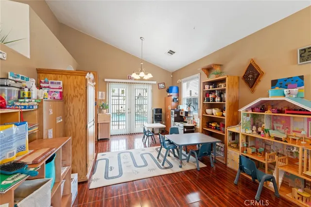 a living room with furniture and a book shelf