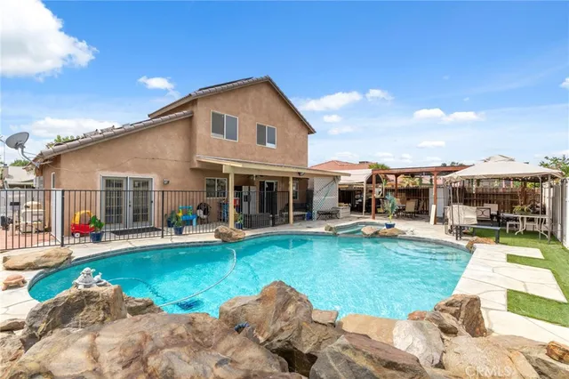 a view of a house with swimming pool and porch