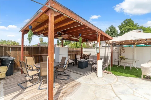 a view of a patio with a table chairs and a backyard