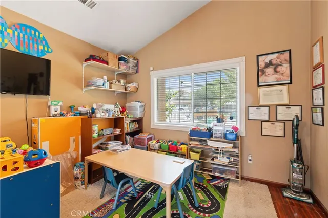 a room with furniture a flat screen tv and a window