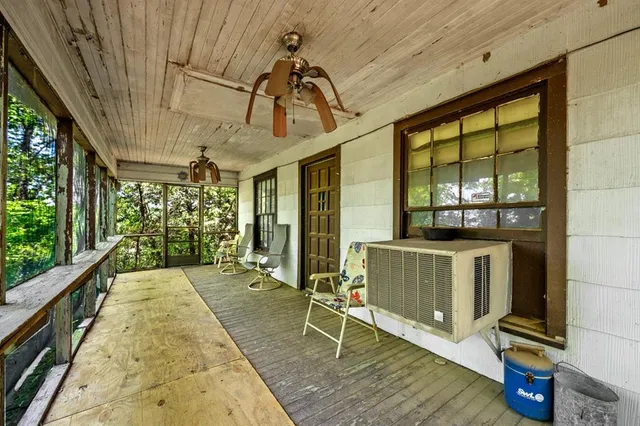 a porch with a table and chairs