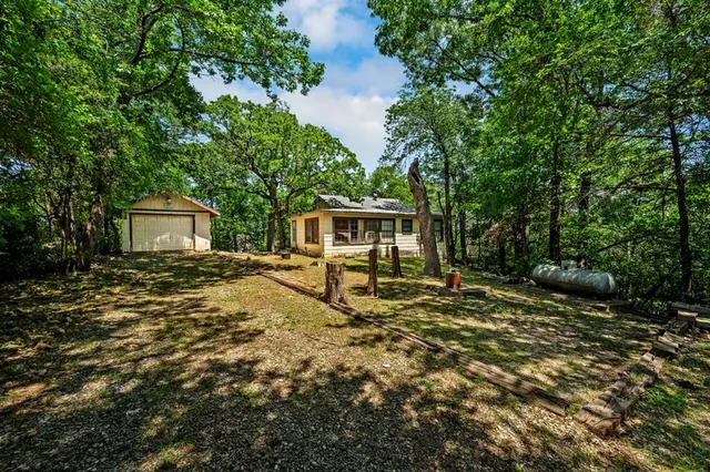 a view of a house with backyard and sitting area