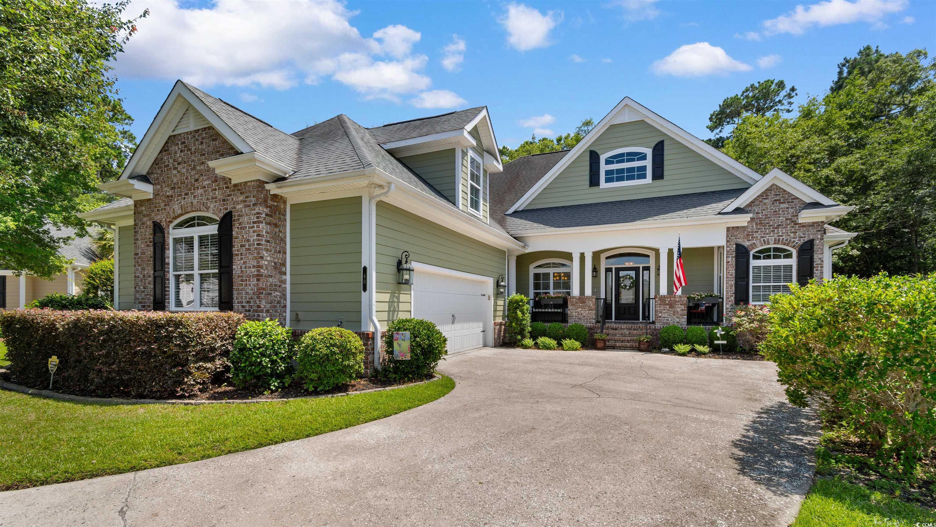 60 Springtime Court Murrells Inlet, SC 29576 - Photo 1 of 40 Craftsman inspired home featuring covered porch, brick siding, concrete driveway, and a shingled roof