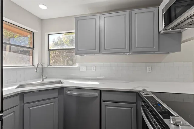 a kitchen with a sink and cabinets