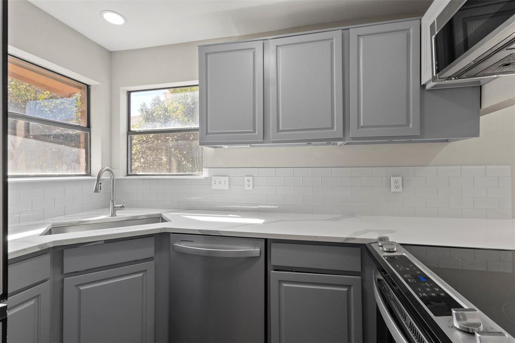 420 Seminary Ridge Mesquite, TX 75149 - Photo 11 of 36 a kitchen with a sink and cabinets