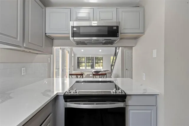 a kitchen with a stove and a microwave