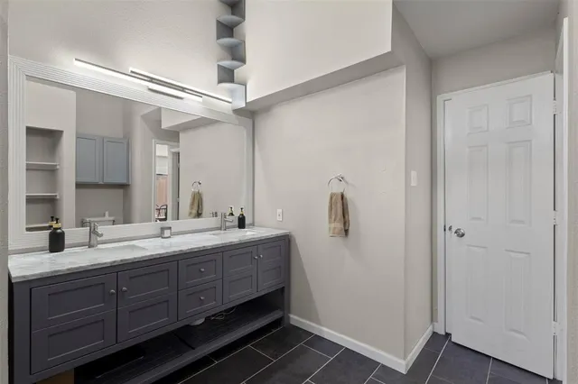 a bathroom with a double vanity sink and mirror