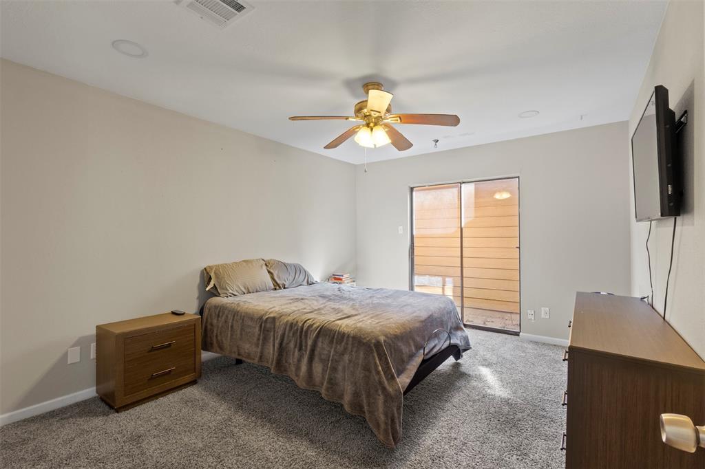 420 Seminary Ridge Mesquite, TX 75149 - Photo 17 of 36 a bedroom with a bed and a chandelier