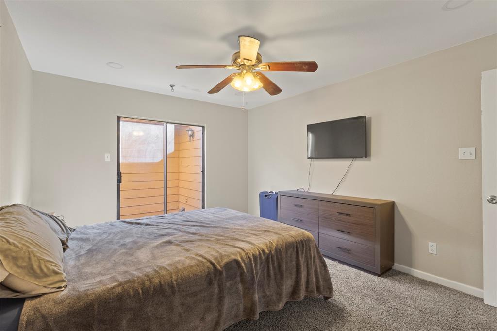 420 Seminary Ridge Mesquite, TX 75149 - Photo 18 of 36 a bedroom with a bed and a flat screen tv