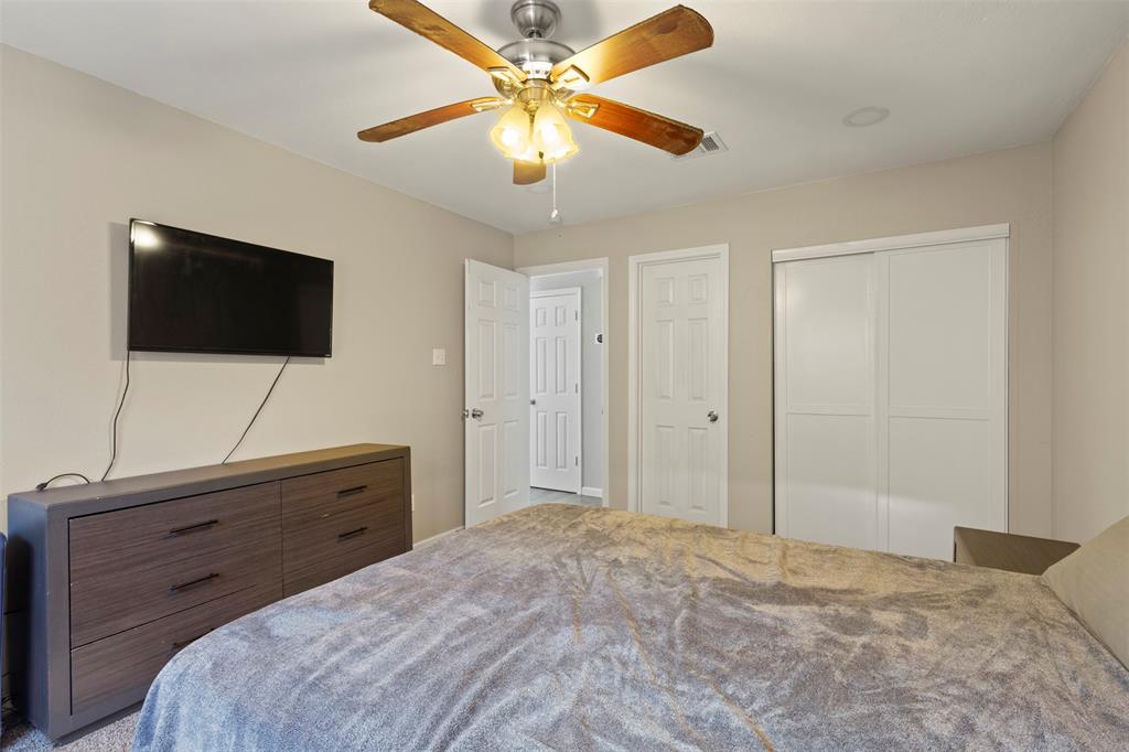 420 Seminary Ridge Mesquite, TX 75149 - Photo 19 of 36 a bedroom with a bed and a flat screen tv