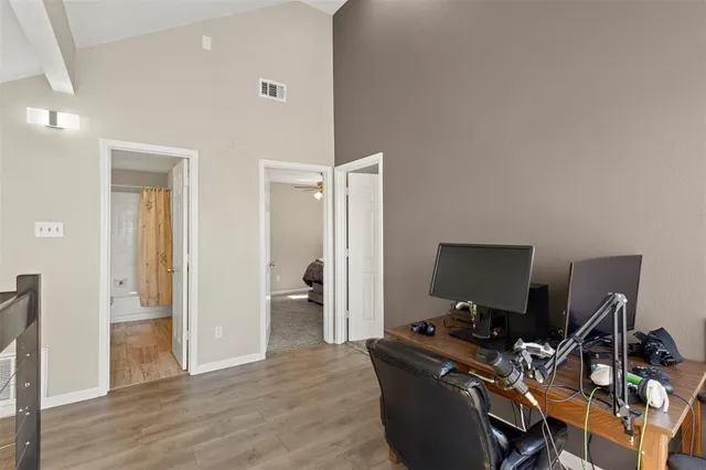 a view of a workspace with furniture and a window