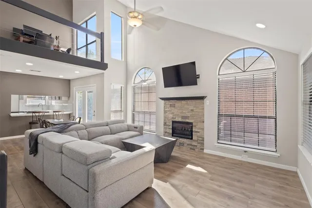 a living room with furniture a fireplace and a flat screen tv