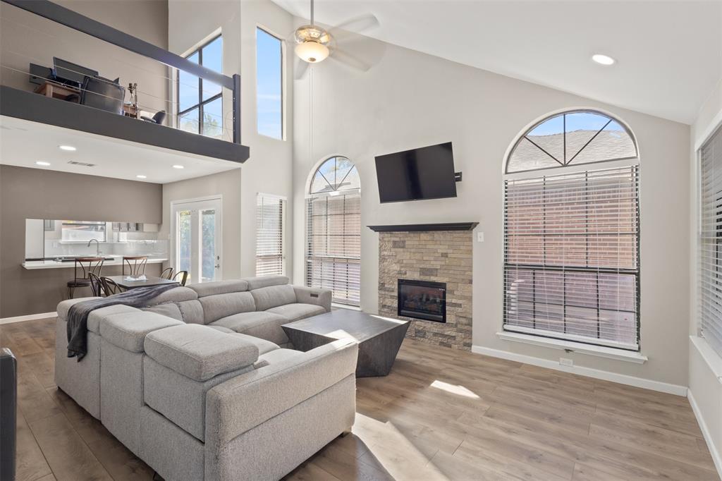 420 Seminary Ridge Mesquite, TX 75149 - Photo 5 of 36 a living room with furniture a fireplace and a flat screen tv